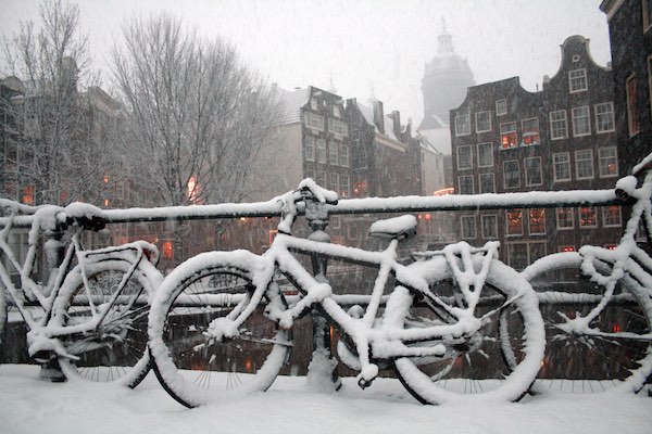 Bicycles covered in snow in Amsterdam in winter